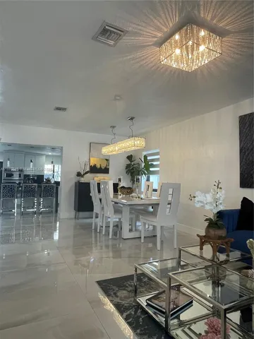 a living room with lots of furniture and chandelier