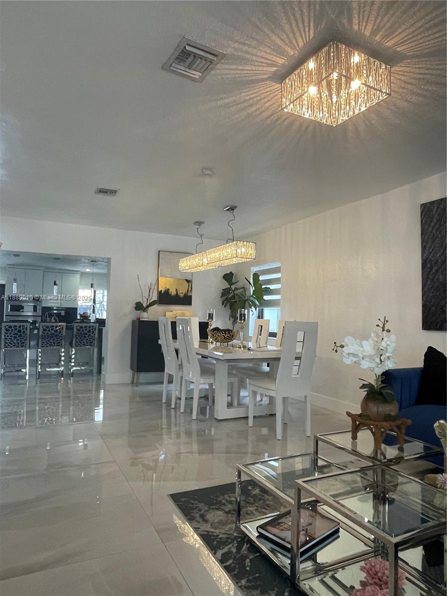 390 East 53rd Street Hialeah, FL 33013 - Photo 6 of 21 a living room with lots of furniture and chandelier