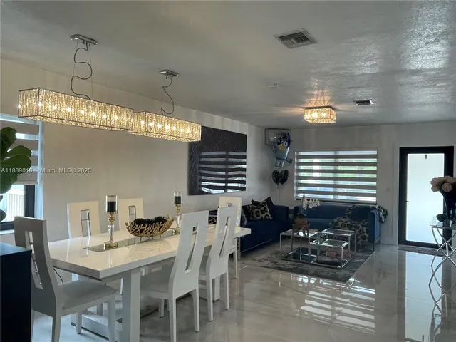 a dining room with furniture and window