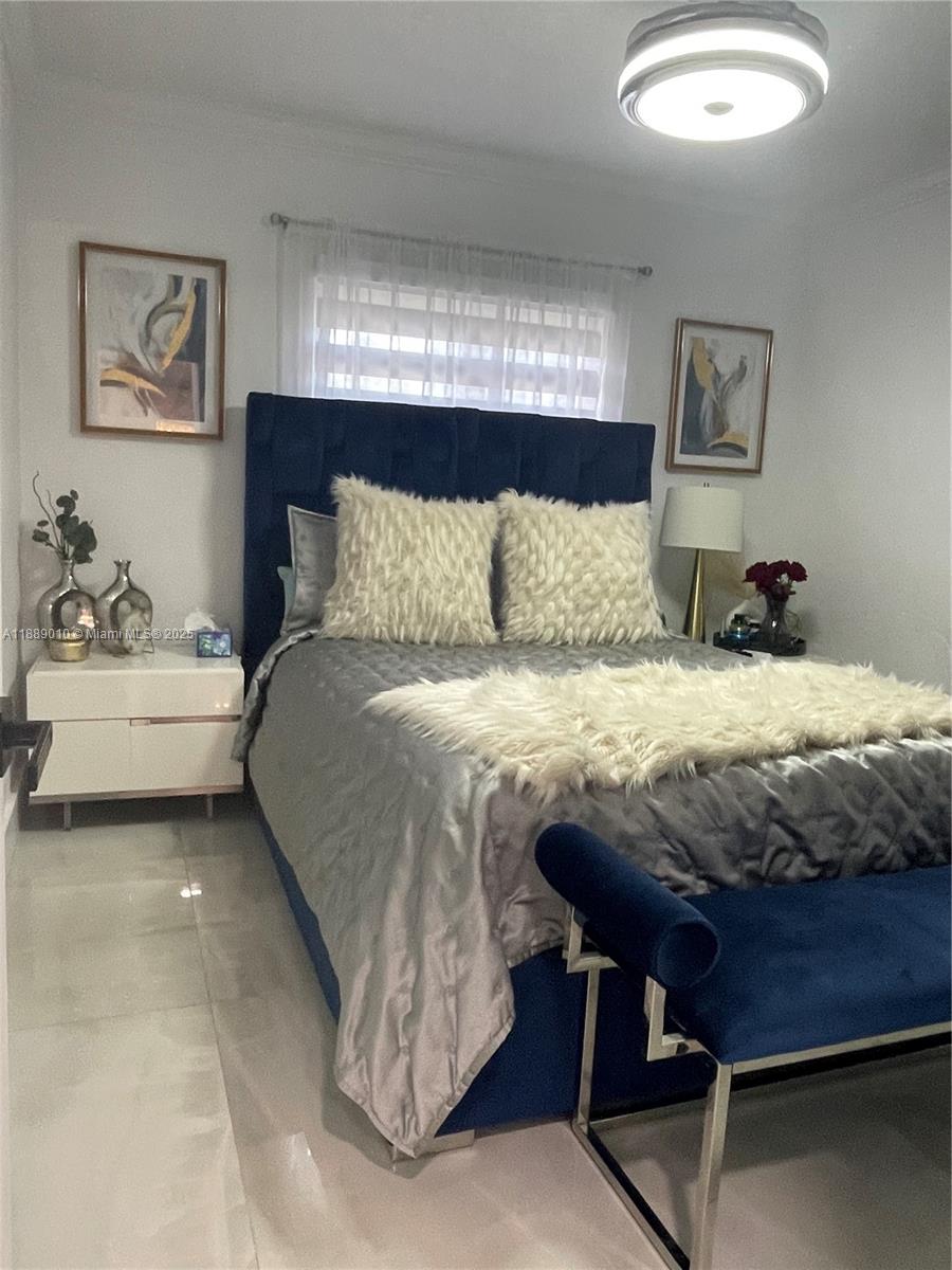390 East 53rd Street Hialeah, FL 33013 - Photo 10 of 21 a bedroom with a bed and window
