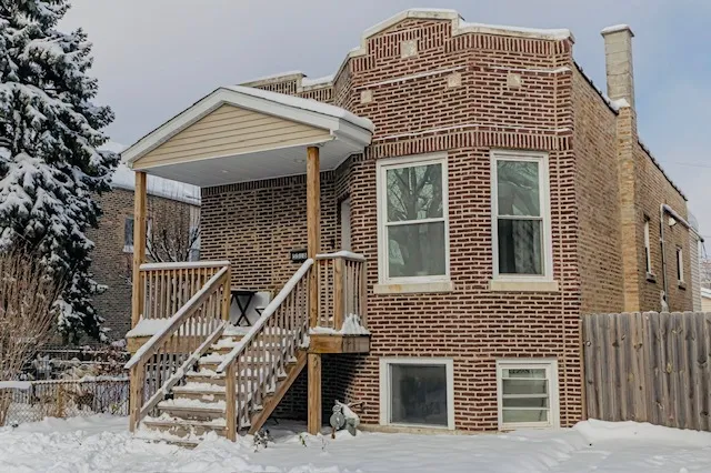 a front view of a house with stairs