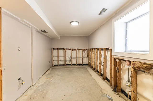 a view of walk in closet with clothes