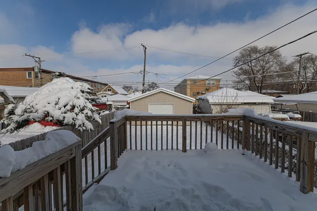 a view of a house with backyard and wooden fence