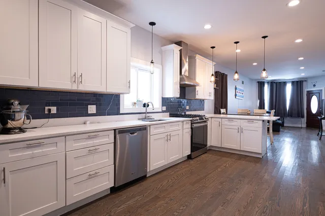 a kitchen with a white cabinets and sink