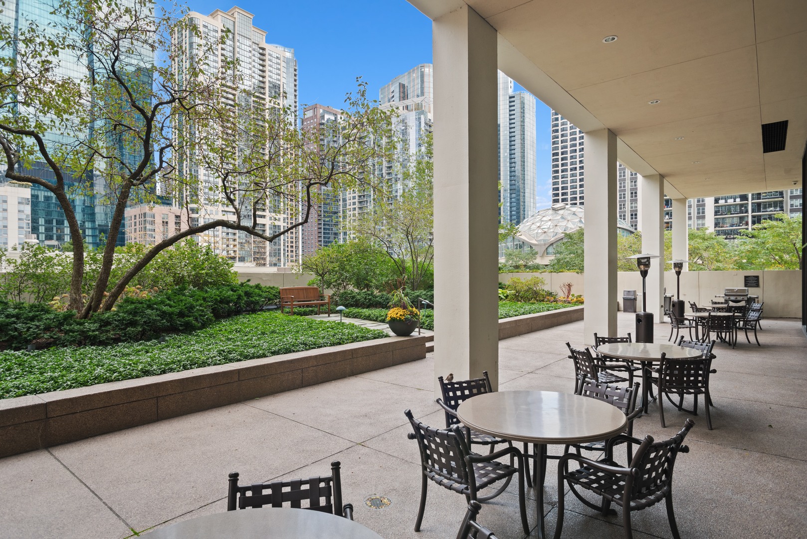 360 East Randolph Street, Unit 707 Chicago, IL 60601 - Photo 20 of 20 a view of a patio with table and chairs and floor to ceiling window