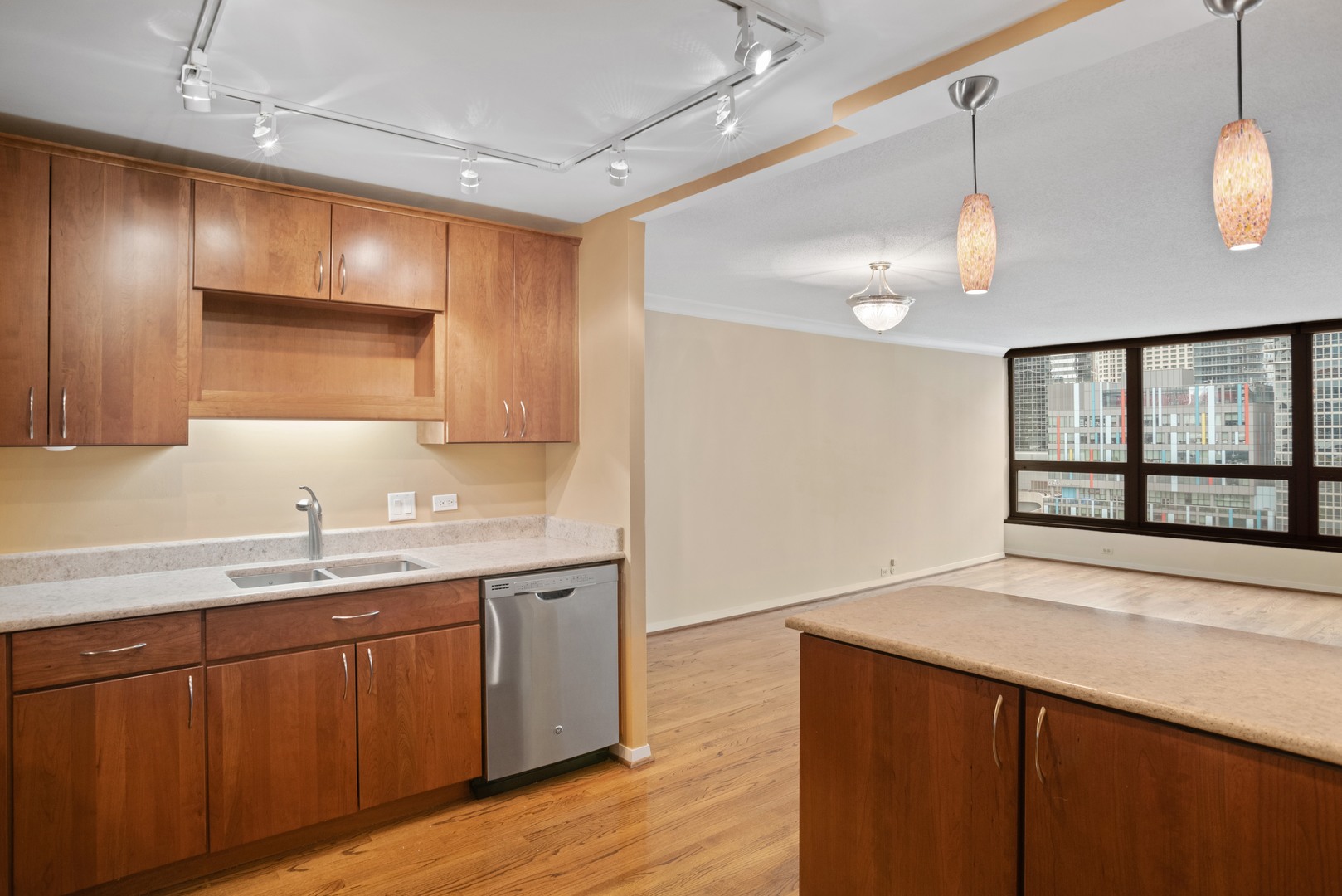 360 East Randolph Street, Unit 707 Chicago, IL 60601 - Photo 8 of 20 a kitchen with a sink cabinets and wooden floor