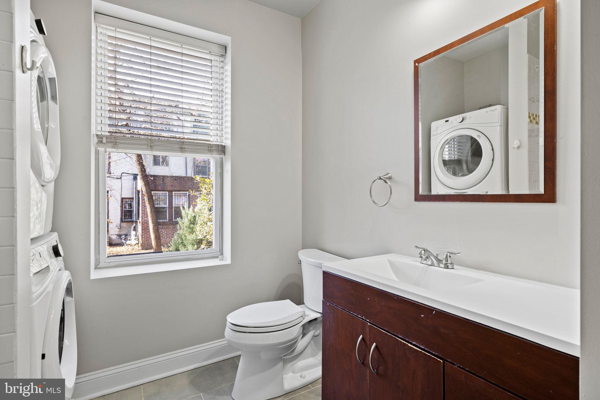 426 South 44th Street, Unit 2 Philadelphia, PA 19104 - Photo 25 of 31 a bathroom with a toilet a sink and a mirror