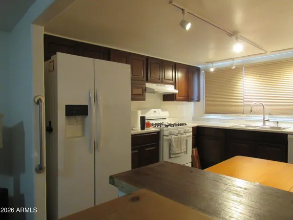 a kitchen with stainless steel appliances a sink a stove and a window