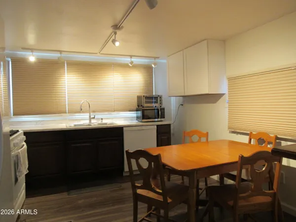 a kitchen with stainless steel appliances granite countertop a refrigerator a sink and a stove