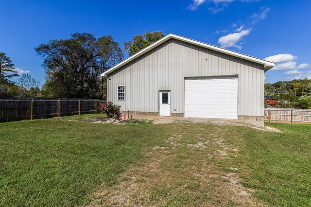 a view of an house with backyard space and garden