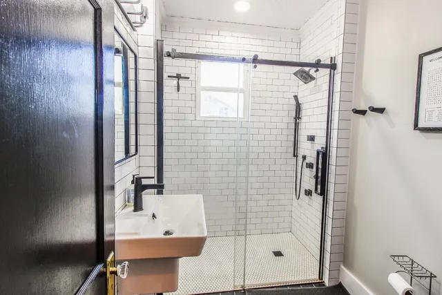 a bathroom with a shower and a sink