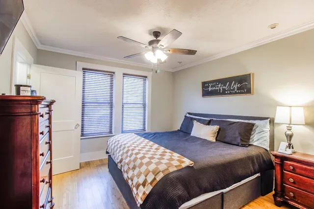 a bedroom with a bed and wooden floor