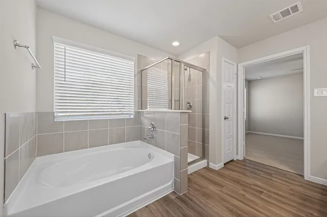 a spacious bathroom with a double vanity sink and mirror
