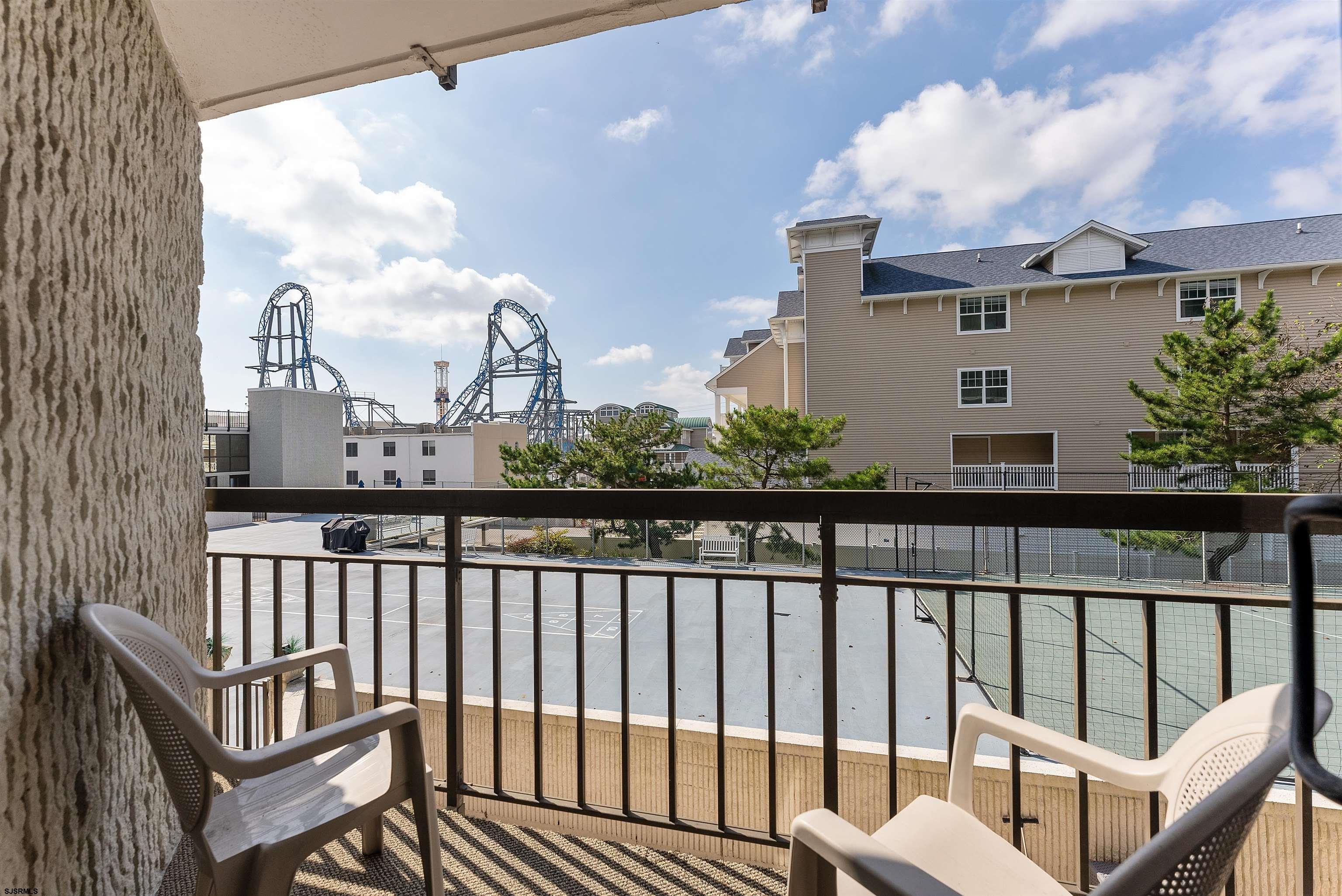 935 Ocean Avenue, Unit 319 Ocean City, NJ 08226 - Photo 12 of 24 a view of a balcony with wooden chairs
