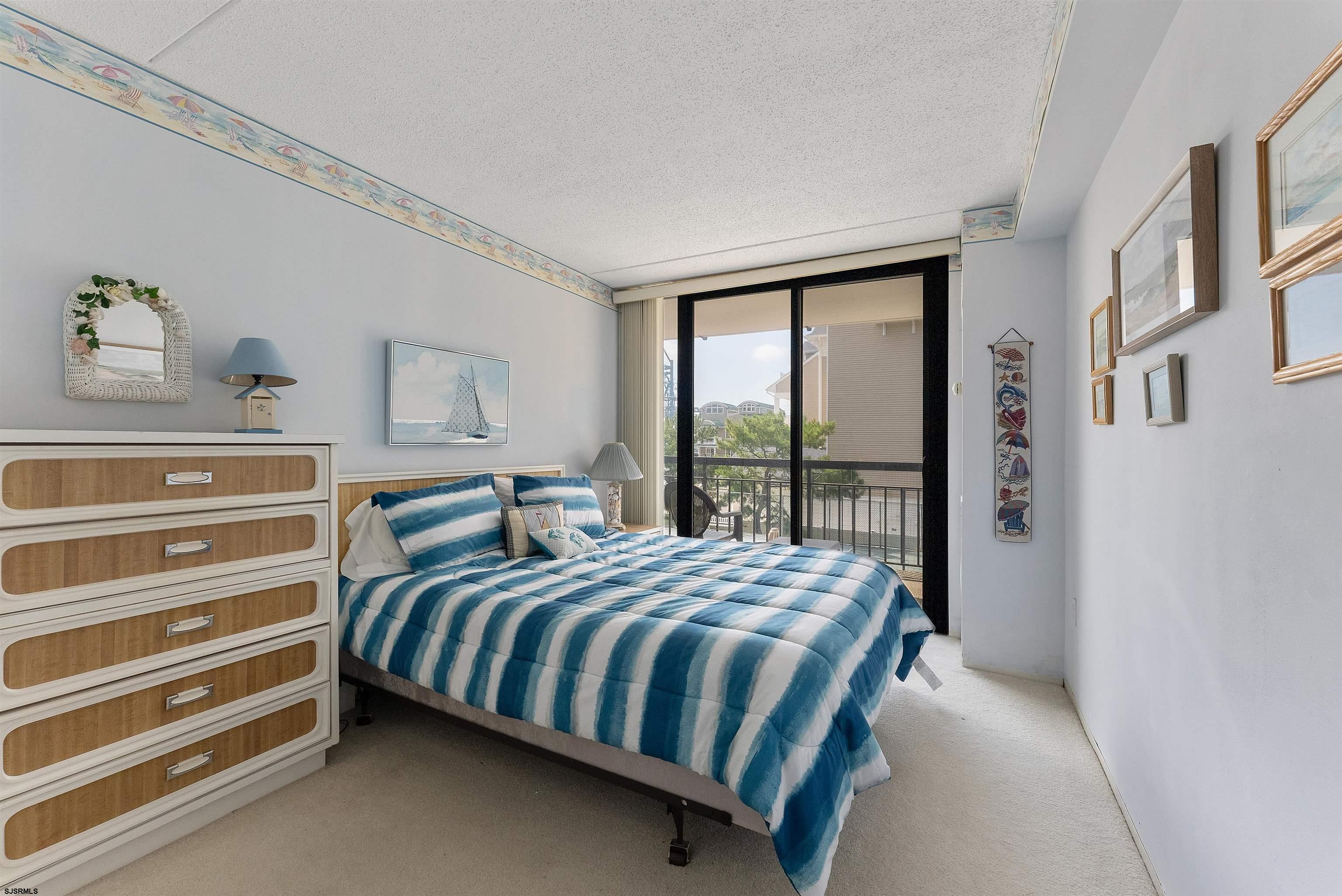 935 Ocean Avenue, Unit 319 Ocean City, NJ 08226 - Photo 13 of 24 a bedroom with a bed and a window