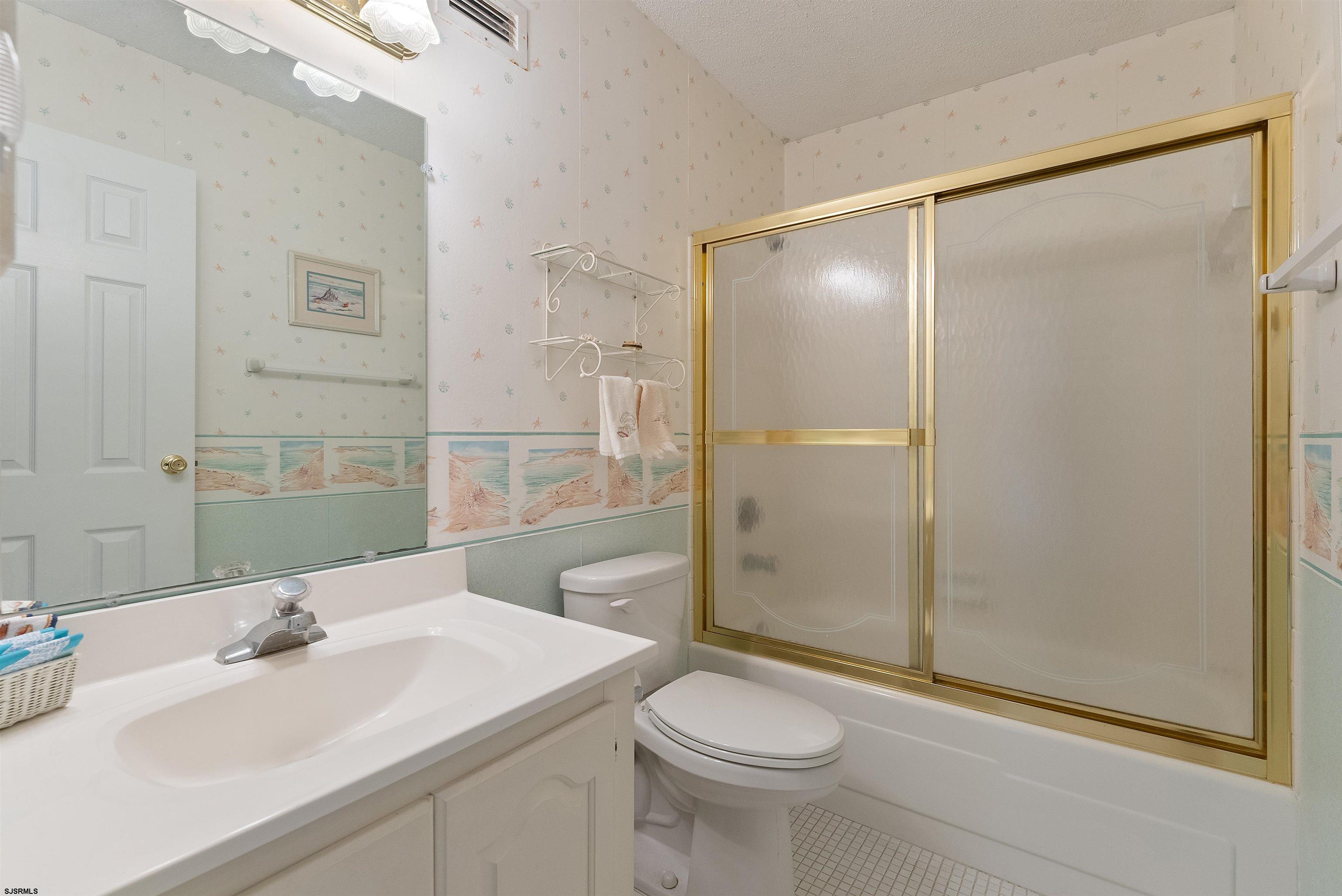 935 Ocean Avenue, Unit 319 Ocean City, NJ 08226 - Photo 14 of 24 a bathroom with a sink toilet and shower