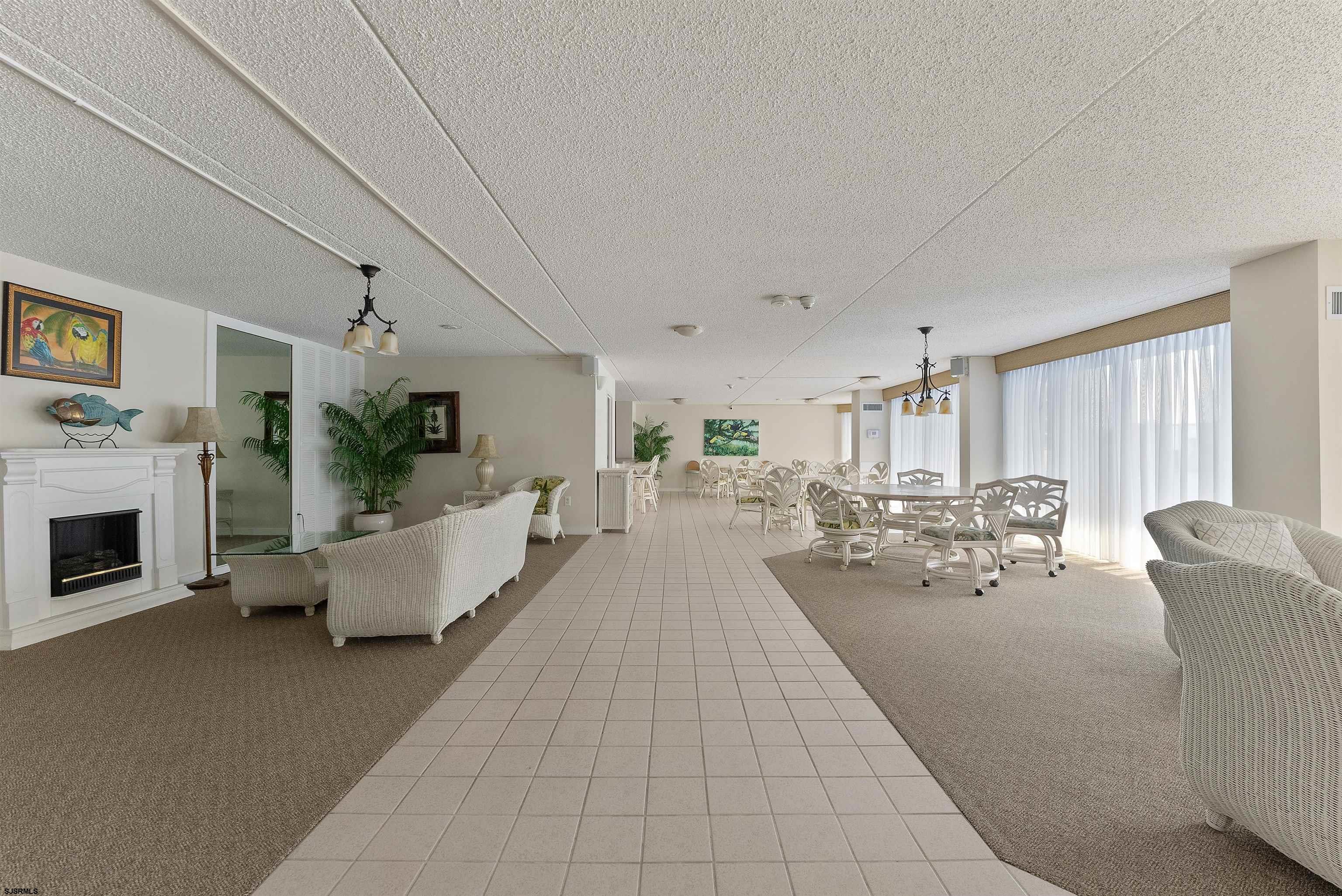 935 Ocean Avenue, Unit 319 Ocean City, NJ 08226 - Photo 17 of 24 a living room with furniture fireplace and flat screen tv