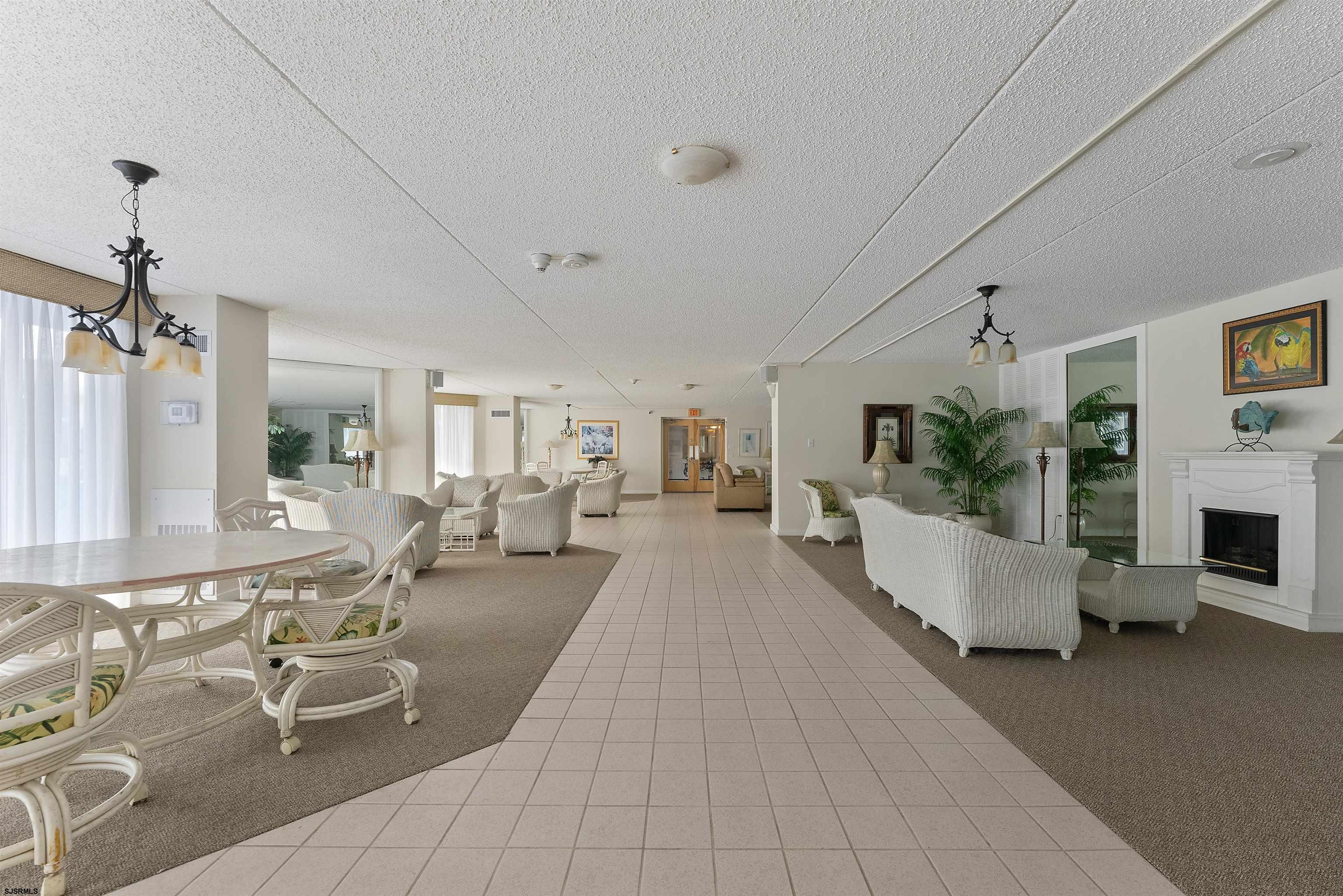 935 Ocean Avenue, Unit 319 Ocean City, NJ 08226 - Photo 20 of 24 a living room with furniture and a fireplace