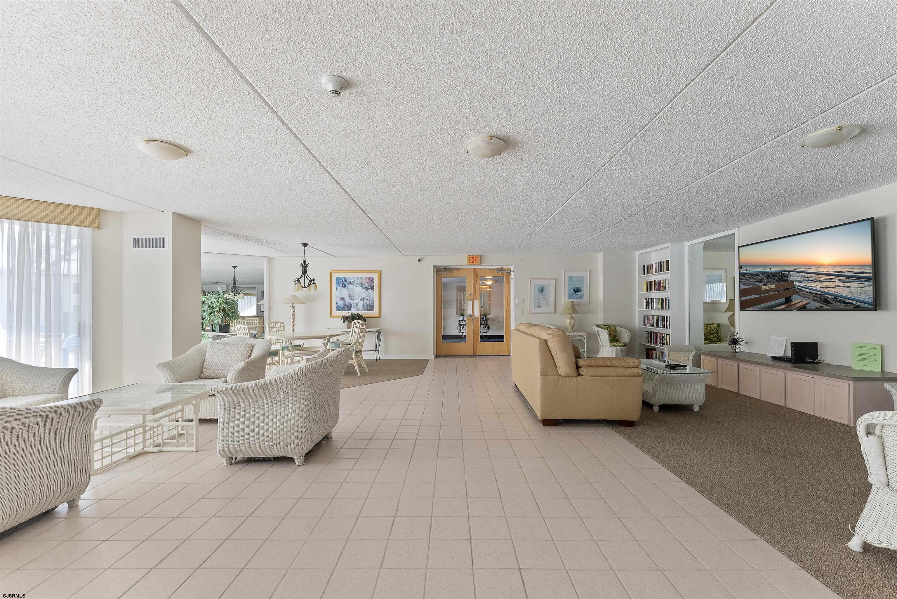 935 Ocean Avenue, Unit 319 Ocean City, NJ 08226 - Photo 21 of 24 a living room with furniture and a flat screen tv