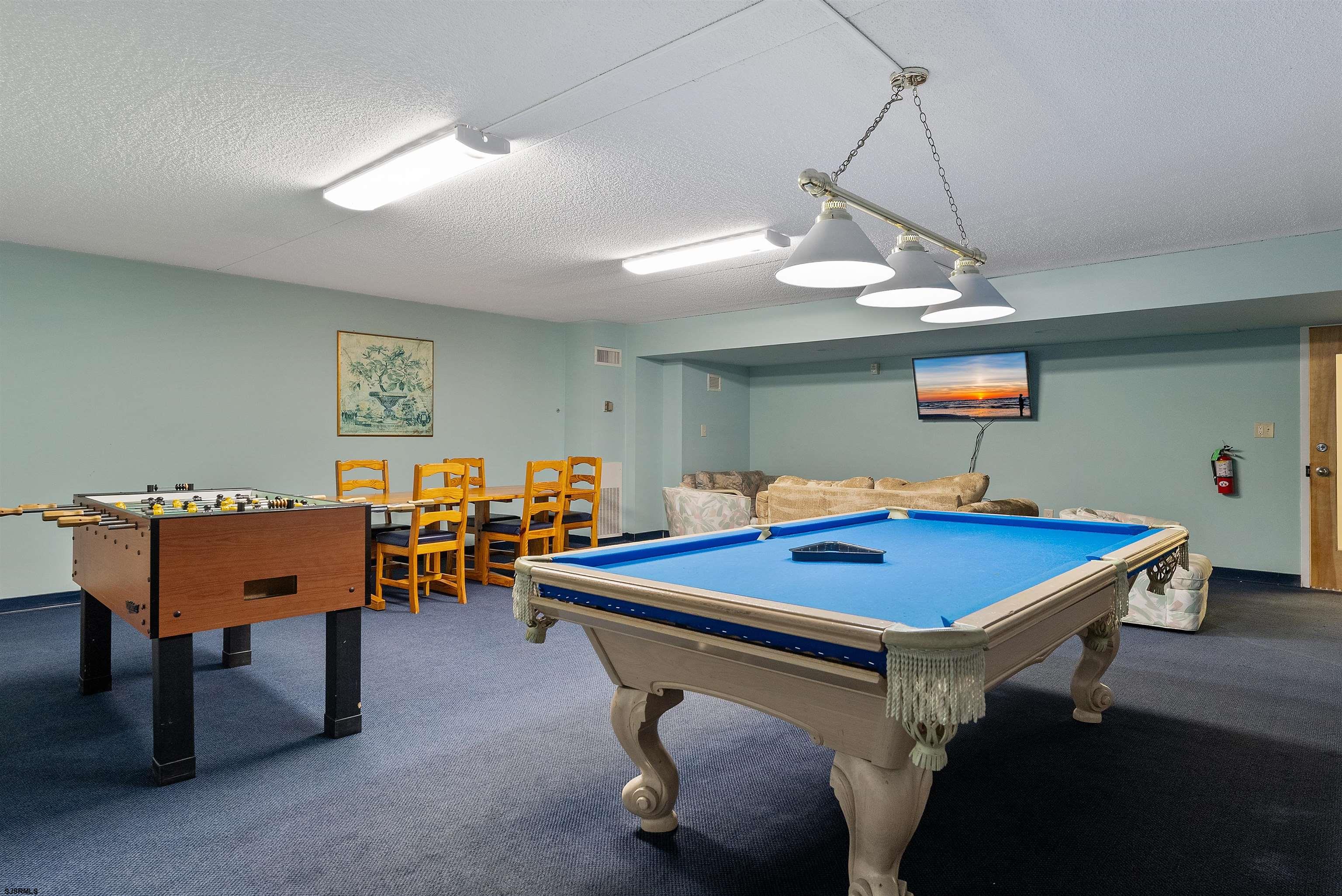 935 Ocean Avenue, Unit 319 Ocean City, NJ 08226 - Photo 22 of 24 a room with furniture pool table and wooden floor