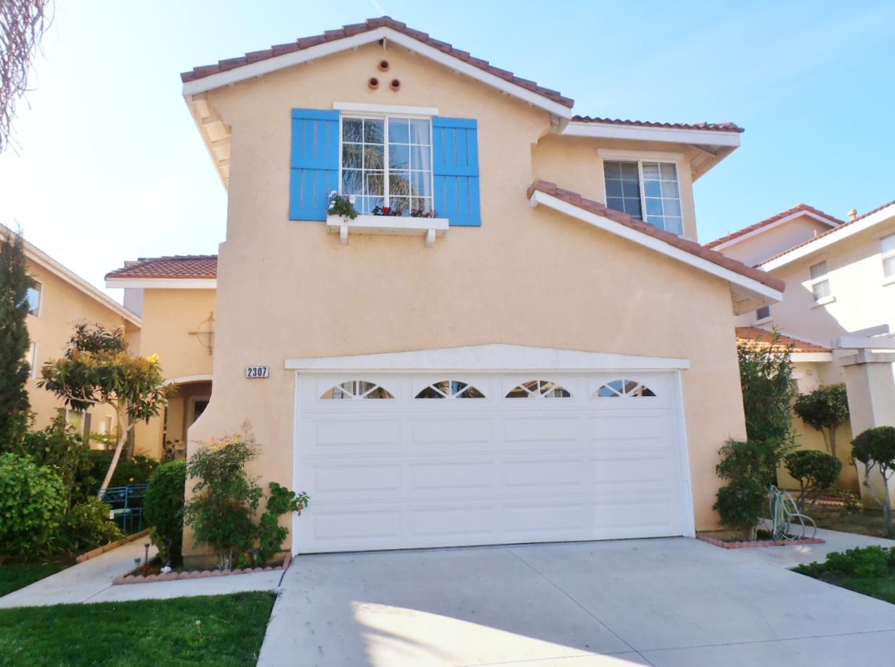 2307 Mint Way Oxnard, CA 93036 - Photo 2 of 39 a front view of a house with garden