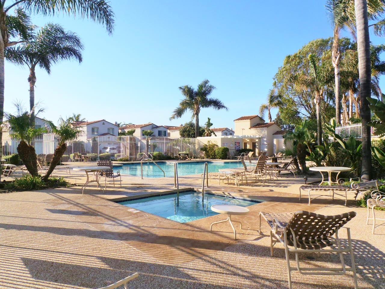 2307 Mint Way Oxnard, CA 93036 - Photo 39 of 39 a view of a swimming pool with a lawn chairs and palm tree