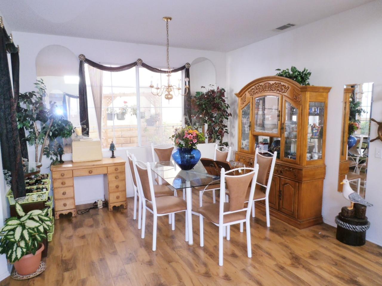 2307 Mint Way Oxnard, CA 93036 - Photo 6 of 39 a dining room with furniture potted plants and wooden floor