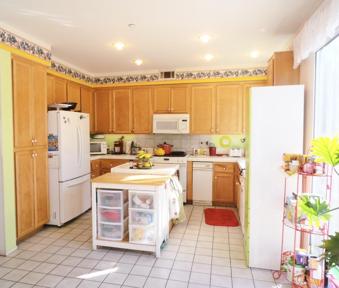 2307 Mint Way Oxnard, CA 93036 - Photo 10 of 39 a kitchen with stainless steel appliances a stove a refrigerator and a refrigerator