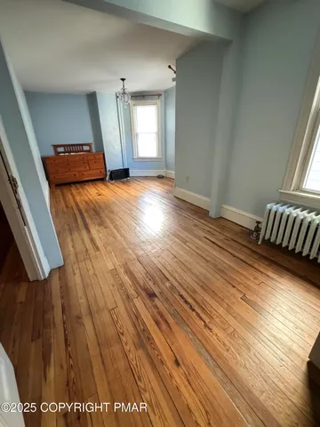 a view of a room with wooden floor
