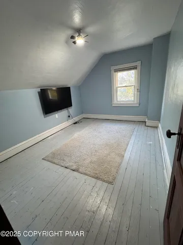 a view of a room with wooden floor