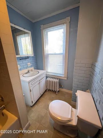 a bathroom with a sink a toilet and tub