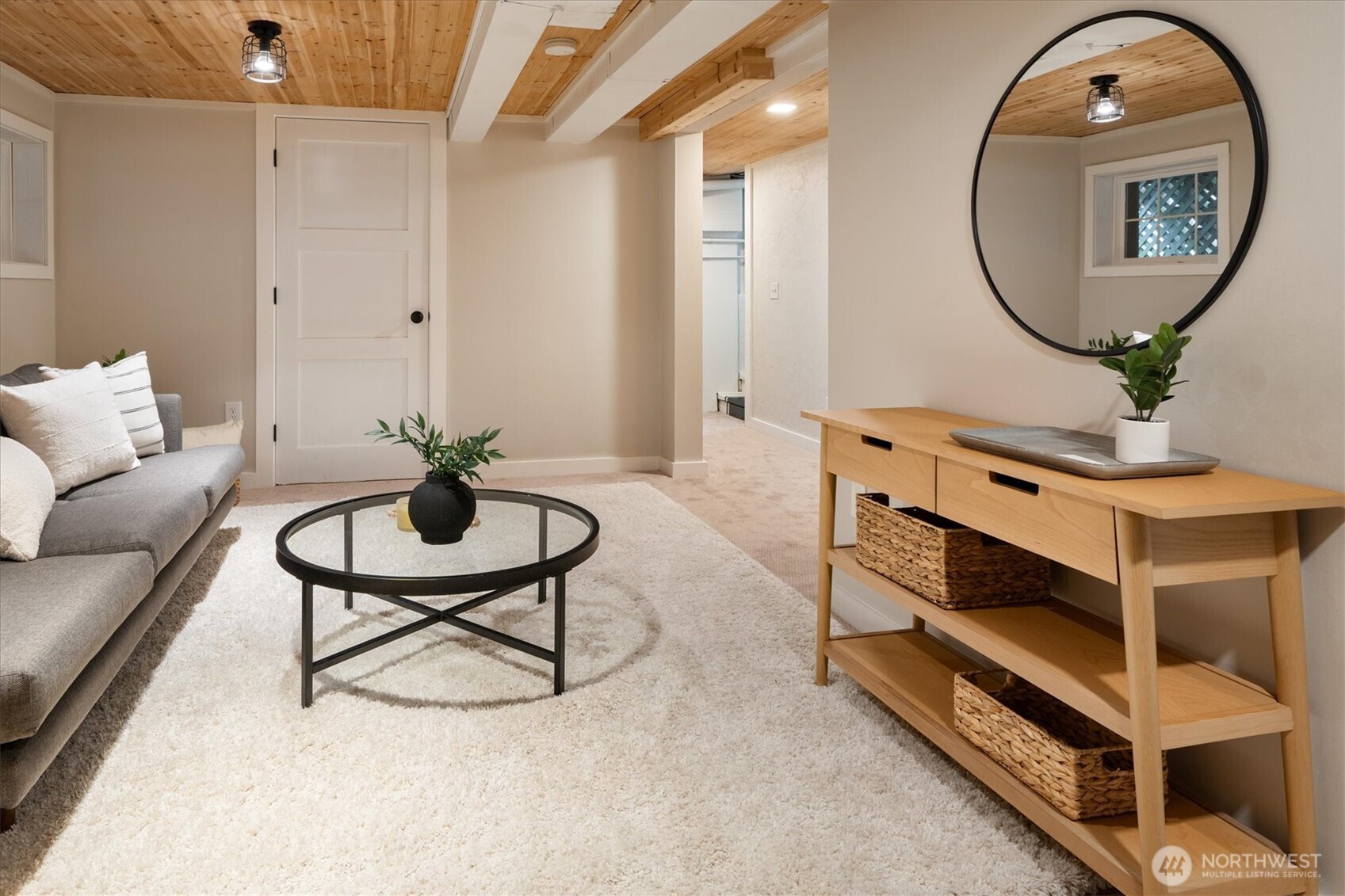 740 North 82nd Street Seattle, WA 98103 - Photo 22 of 36 a living room with furniture a mirror and a wooden floor