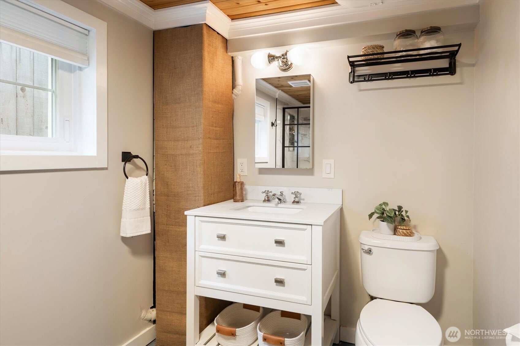 740 North 82nd Street Seattle, WA 98103 - Photo 25 of 36 a bathroom with a sink a toilet and a mirror