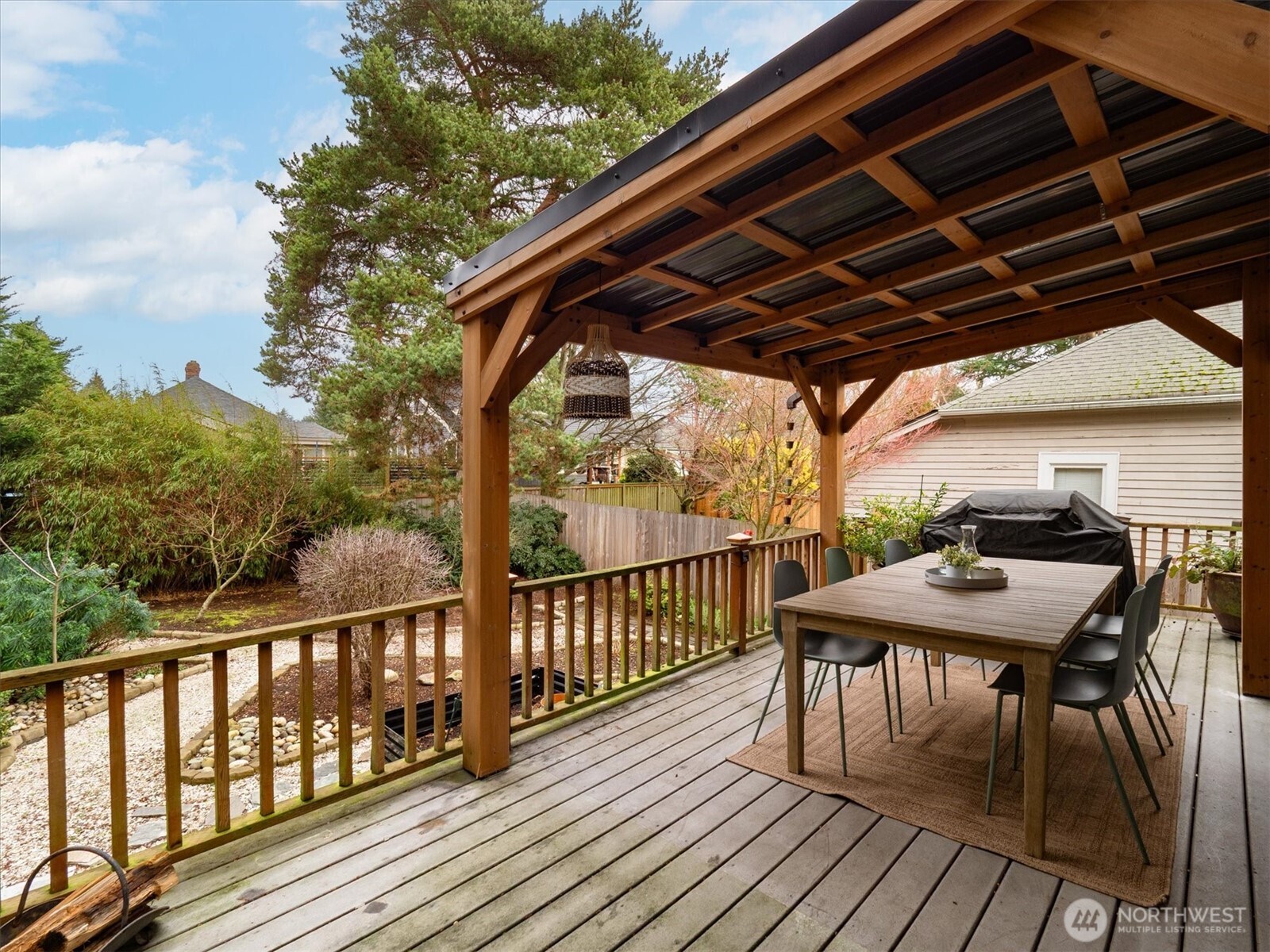 740 North 82nd Street Seattle, WA 98103 - Photo 29 of 36 a roof deck with table and chairs with wooden floor