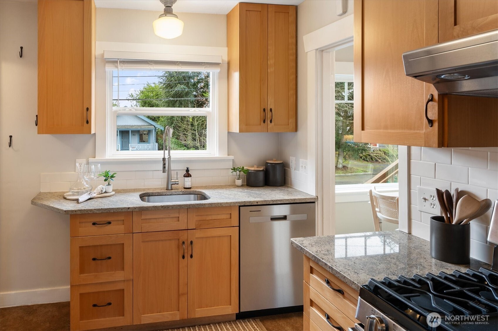 740 North 82nd Street Seattle, WA 98103 - Photo 10 of 36 a kitchen with a sink stove and cabinets