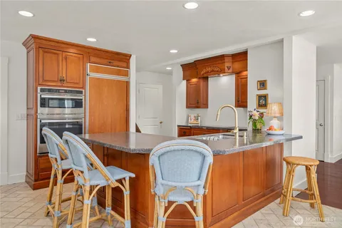 a view of a kitchen area with furniture and wooden floor