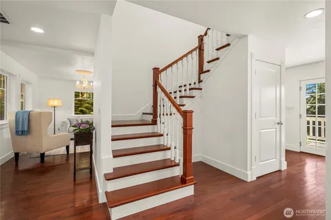 a view of entryway and hall with wooden floor
