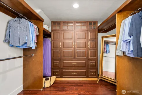 a view of walk in closet with clothes and shoes