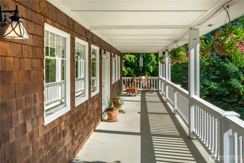 a view of a porch with wooden floor and outdoor seating