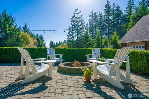 a view of backyard with seating space and trees