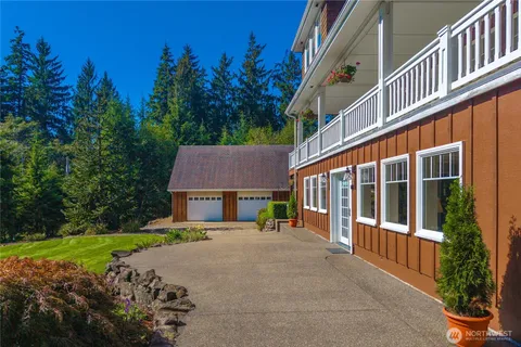 a view of a house with a yard and potted plants