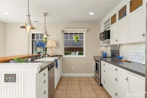 a kitchen with a sink stove and cabinets