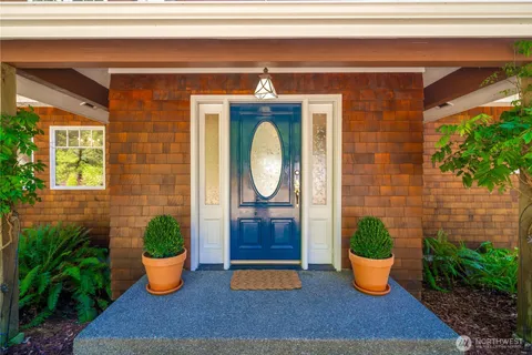 a outdoor view with a chair and potted plants