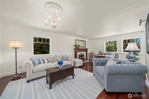 a living room with furniture chandelier and a window
