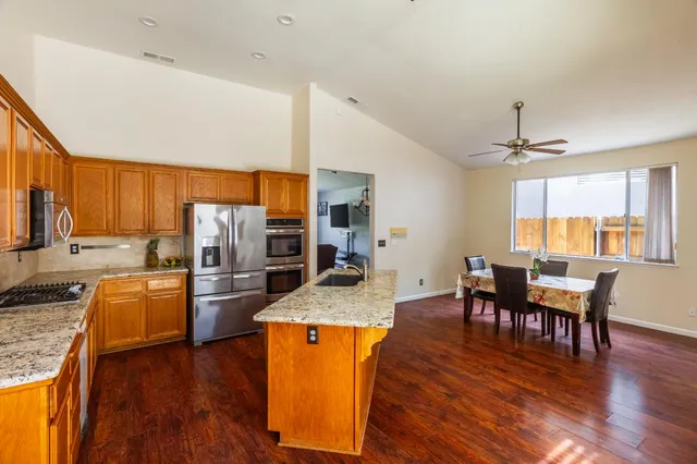 a kitchen with a refrigerator sink and stove