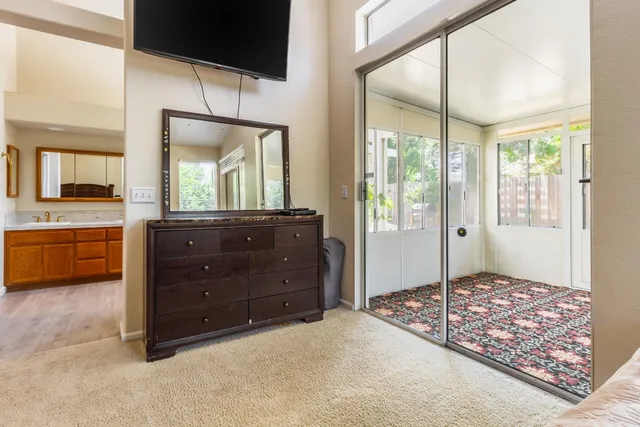 a bedroom with furniture and a large window