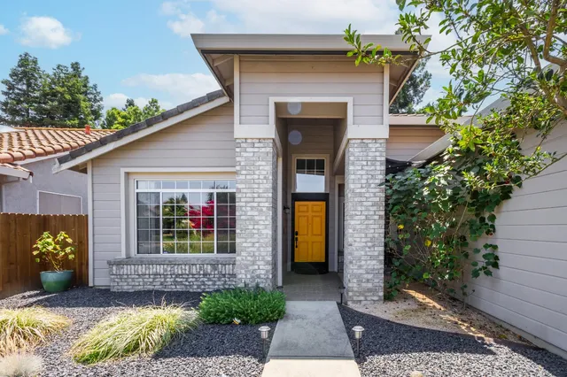 a front view of a house with garden