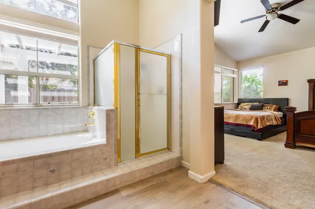 a bathroom with a bathtub and a window