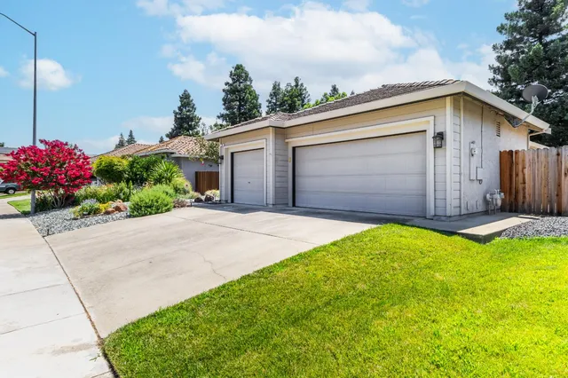 a front view of house with yard and green space
