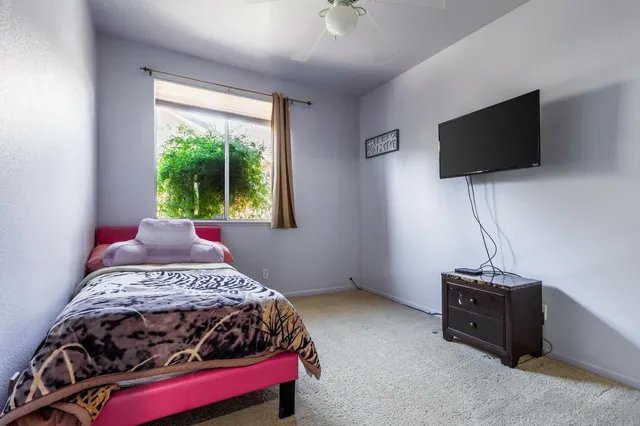 a view of a house with backyard and a tree
